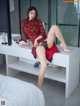 A woman sitting on top of a white table.