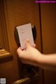 A person is opening a door with a card in their hand.