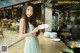 A woman holding a plate of food in a restaurant.