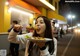 A woman eating a plate of food on a city street.