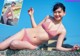 A woman in a red and white striped bikini posing for a picture.