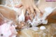 A woman is washing her body with foam. 