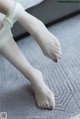 A close up of a person's feet with a bandage on them.