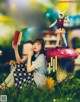 A woman sitting on top of a mushroom holding a book.