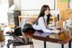 A woman sitting at a table with a laptop computer.